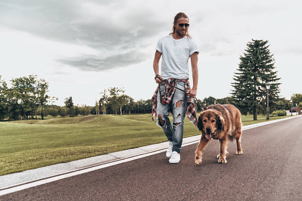 handsome man walking with dog - Фото, изображение
