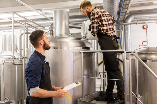 men working at craft brewery or beer plant - Φωτογραφία, εικόνα