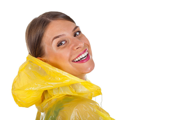 Attractive woman wearing yellow raincoat - isolated - Zdjęcie, obraz