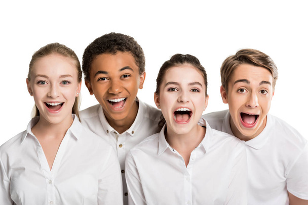 gritando adolescentes multiétnicos en camisas blancas
 - Foto, Imagen