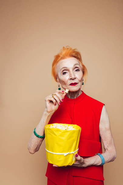 Amazing mature redhead fashion woman eating popcorn - Zdjęcie, obraz