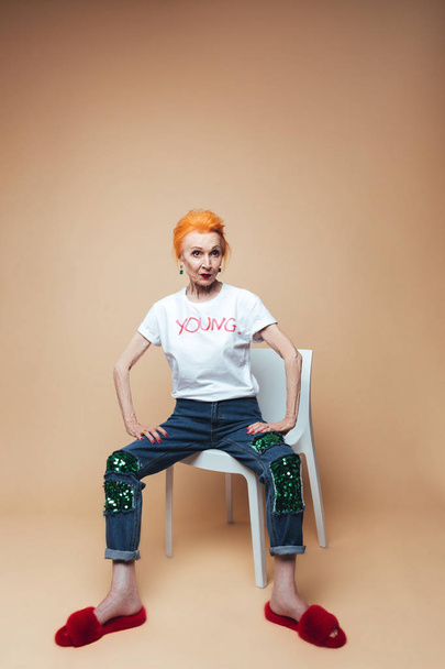 Mature redhead fashion woman sitting isolated - Zdjęcie, obraz