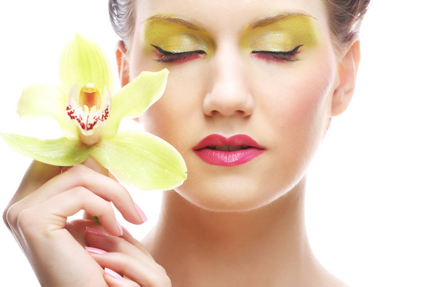 young woman with bright make up holding orchid - Foto, immagini