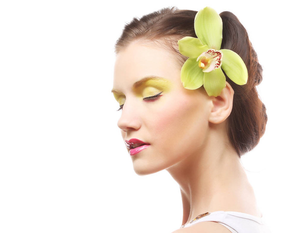 Beautiful stylish girl with orchid flower in hair. - Zdjęcie, obraz