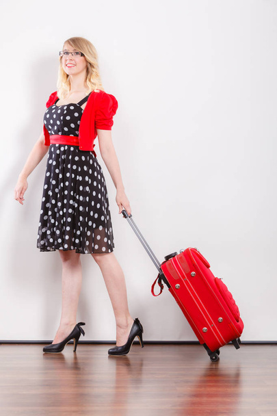 Elegant fashion woman with red suitcase - Foto, afbeelding