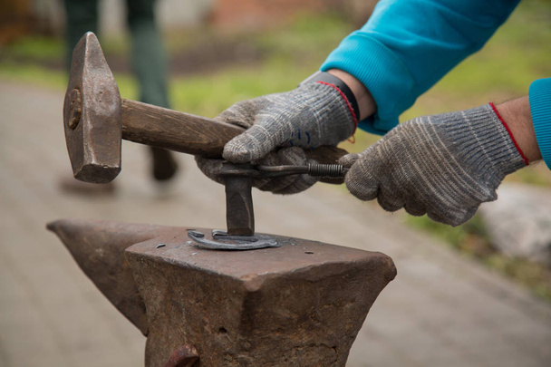 Blacksmith worker hammer gloves horeshoe closeup - Photo, Image