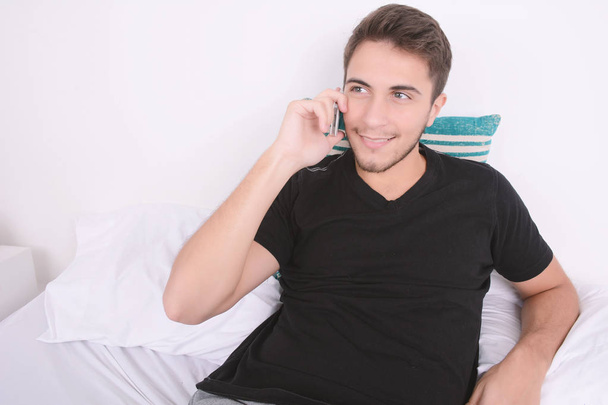 Man talking on phone in bed. - Foto, Imagem