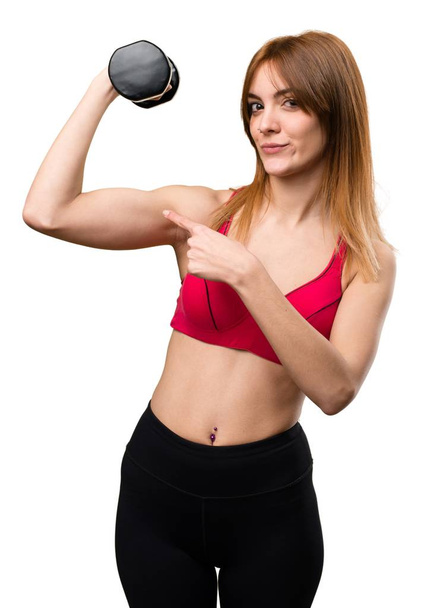 Beautiful sport woman with dumbbells making strong gesture - Foto, Imagem