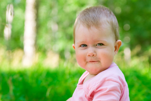 Smiling baby in a wood - Фото, изображение