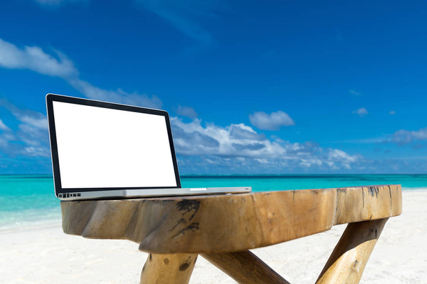 laptop blank screen on wooden desk with beach. relax concept.  - 写真・画像