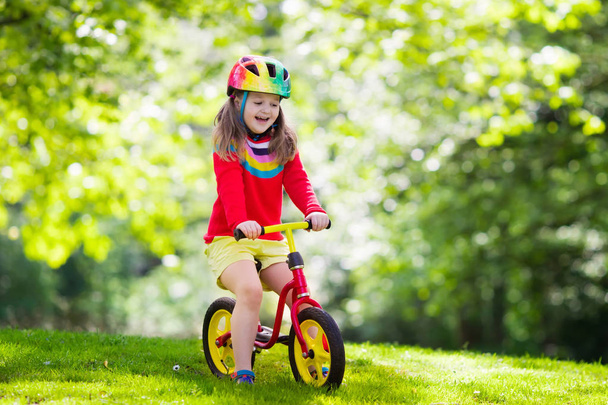 Kids ride balance bike in park - Zdjęcie, obraz
