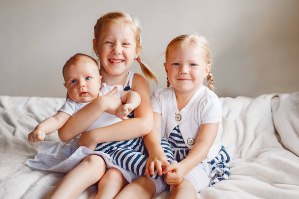  sisters holding little baby - Foto, Imagen