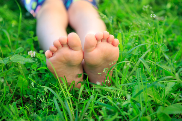 Children's feet on grass. picnic in park - Photo, Image