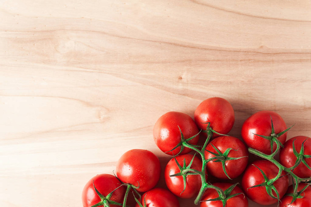A pile of fresh , ripe , delicious red tomatoes on a wooden back - Photo, Image