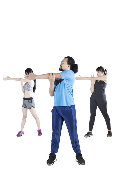 Young people doing stretching together - 写真・画像