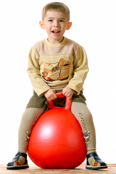 Boy on red sphere - 写真・画像