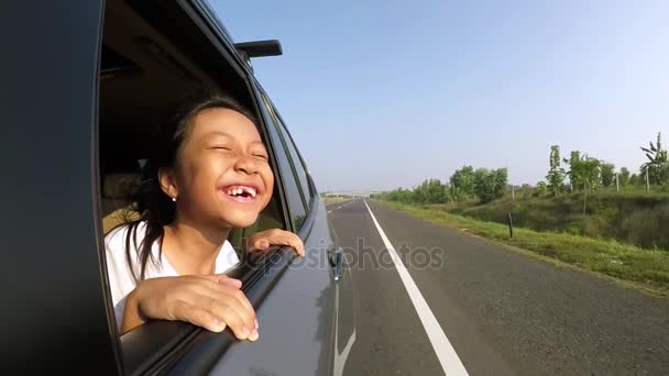 Cheerful girl look out from car windows - Footage, Video