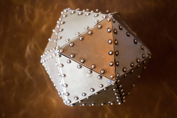 Metal hexagon ball on brown leather background - Photo, Image