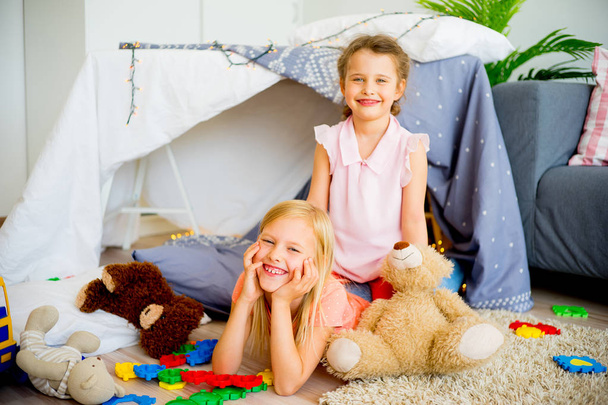 Two sisters in a play tent - Фото, изображение