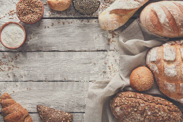 Bread bakery background. Brown and white wheat grain loaves comp - Photo, Image
