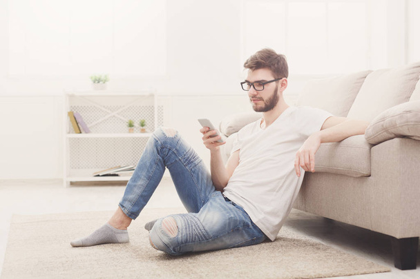 Young man at home messaging online - Foto, Imagen