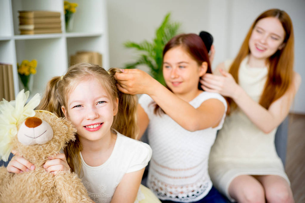 Mother daughter doing hair together - Photo, Image