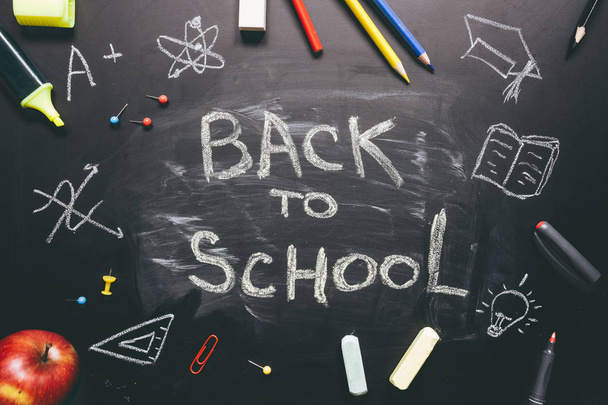 Back to school. School supplies on the chalkboard background, education concept - 写真・画像