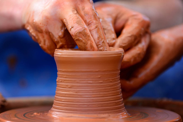 Potter making ceramic pot on the pottery wheel - Photo, Image