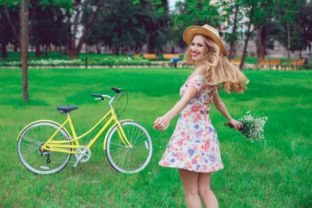 Beautiful happy young woman enjoying summer with wild-flower bunch - Foto, Imagen