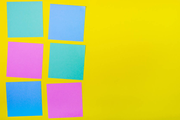 Colorful documents with copy space on a colored background. View from above. For notes and ideas. - 写真・画像