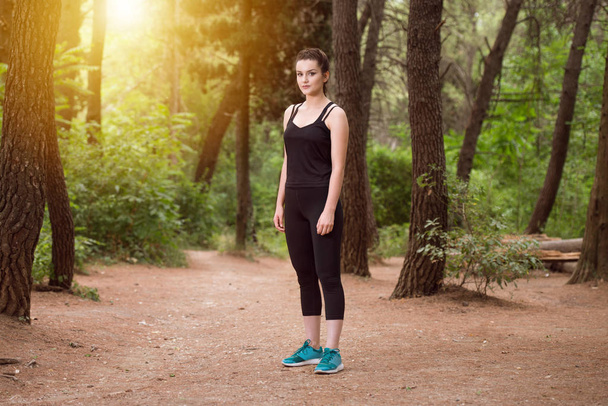 Portrait of a Fit Girl Running Outdoors - 写真・画像