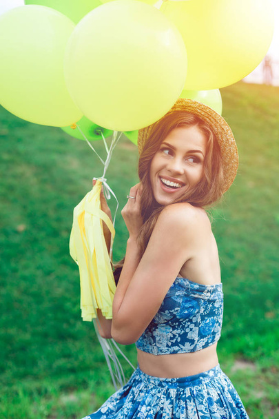Joven mujer feliz con globos coloridos sonriendo y riendo
 - Foto, Imagen