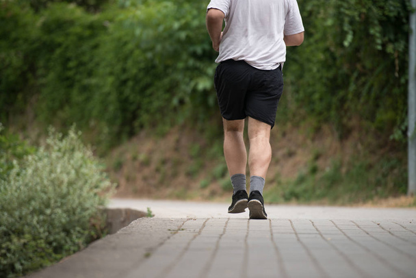 Close-up Man Running Outdoors Trying Weight Loss - 写真・画像
