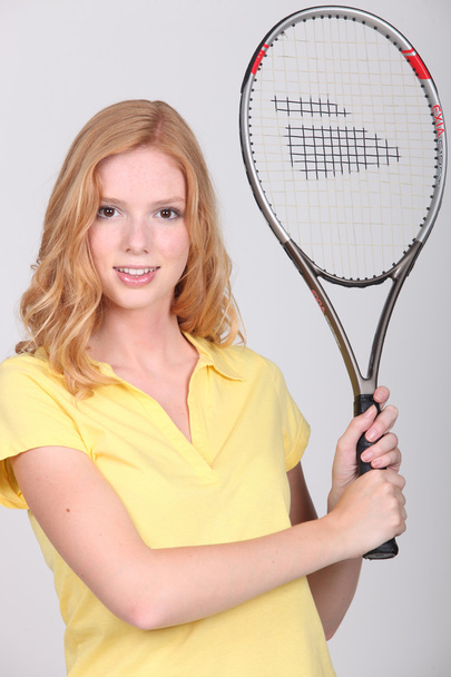 Teenager holding a tennis racket - Fotó, kép