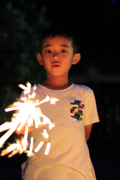 Japanese boy doing handheld fireworks (second grade at elementary school) - Photo, Image
