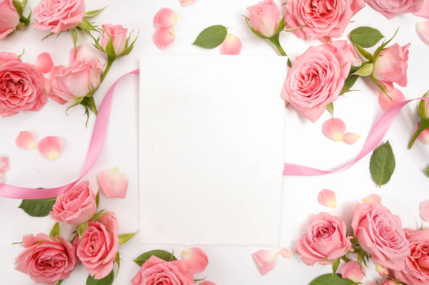 Framework from roses on white background. Flat lay, top view - Foto, imagen
