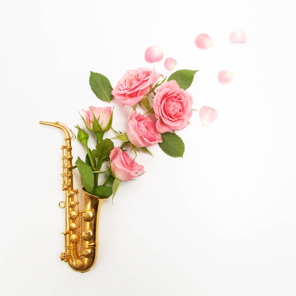 Jazz Day. Saxophone with flowers. Flat lay, top view - Photo, image