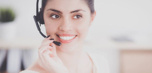 Close-up portrait of a customer service agent sitting at office - Photo, Image