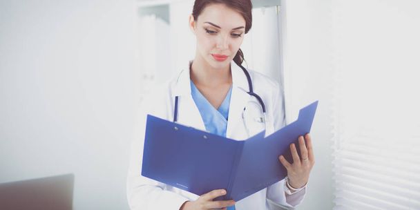 Portrait of young woman doctor with white coat standing in hospital - Foto, Bild