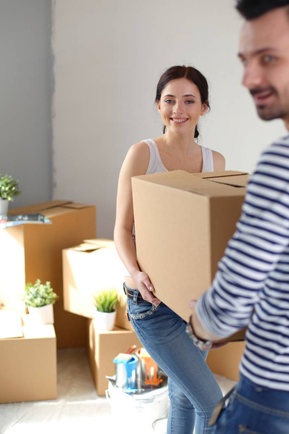 Happy young couple unpacking or packing boxes and moving into a new home. young couple - Φωτογραφία, εικόνα