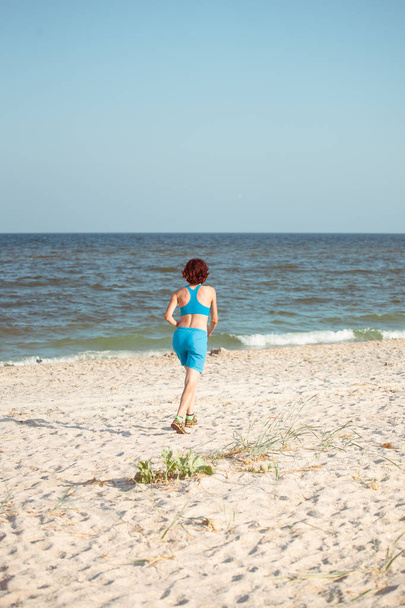 Running on the beach. - Фото, изображение