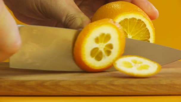 Man's hand sliced orange on chopping board closeup - Video
