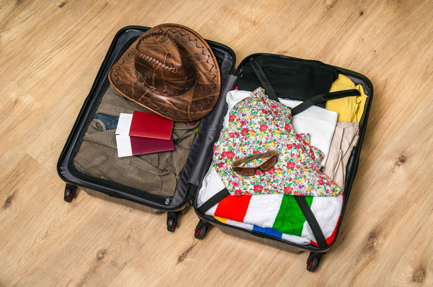Open suitcase packed for travelling - Photo, Image