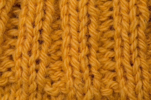 Ένα όμορφο closeup ενός μοτίβου πλεκτό μαλλί ζεστά και μαλακά το χέρι. Μαλακό κάλτσες ή κασκόλ από φυσικό μαλλί. Πολύχρωμο μοτίβο. - Φωτογραφία, εικόνα