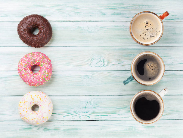 Coffee cup and colorful donuts - Photo, Image