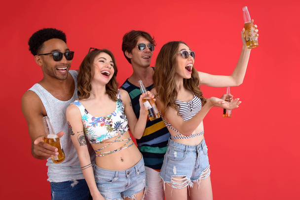 Cheerful group of friends with beer standing isolated - Foto, imagen