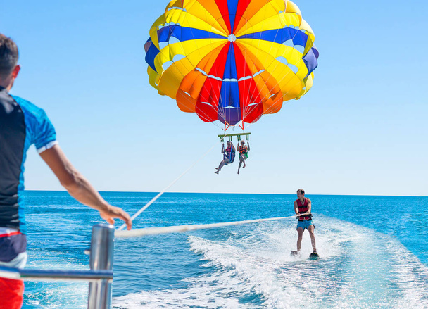 Happy couple Parasailing in Dominicana beach in summer. Couple u - Photo, Image