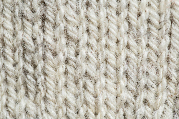 A szép closeup egy kézzel kötött meleg és puha gyapjú minta. Puha zokni vagy sál, természetes gyapjú. Színes minta. - Fotó, kép