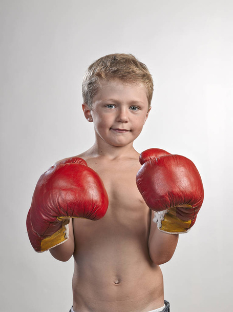 Caucasian kid with red and yellow gloves - Fotografie, Obrázek