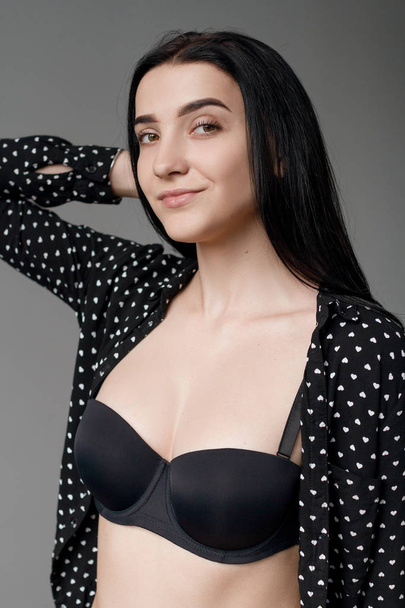 Beautiful brunette in black lingerie and in a shirt in a bright room - Zdjęcie, obraz